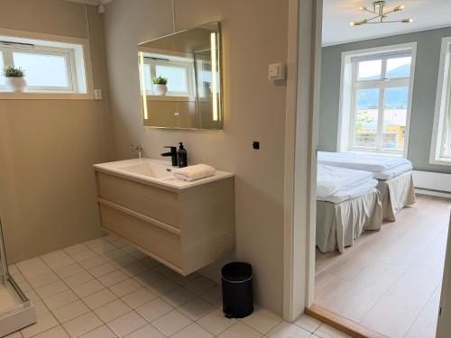 a bathroom with a sink and a bed at Charming apartment with free parking close to Ålesund center in Ålesund