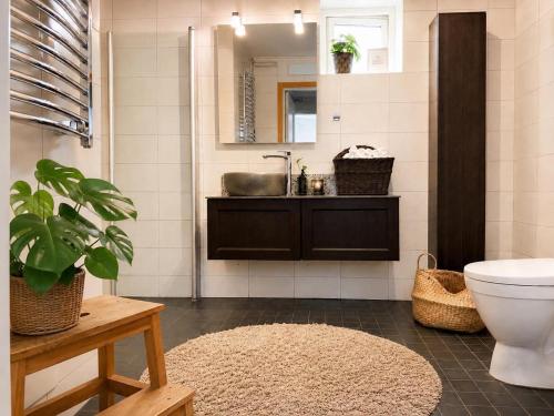 a bathroom with a sink and a toilet and a mirror at Rum För Resande in Skellefteå