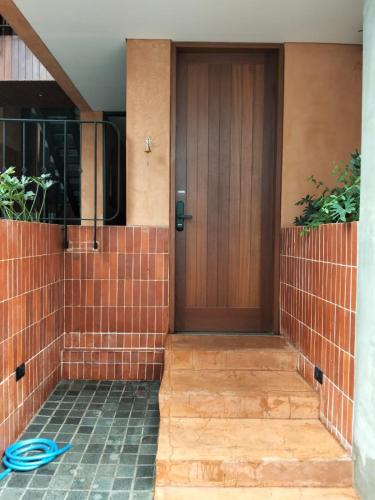a front door of a house with a blue hose at Hakon Canggu Boutique Hostel in Canggu
