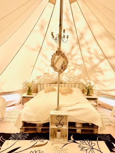a bedroom with a bed in a tent at Muhu Leeni Glamping in Kuivastu