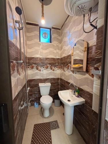 a bathroom with a toilet and a sink at Luxury Mountain Chalet with Private Pool Lionden Jerash in Jerash
