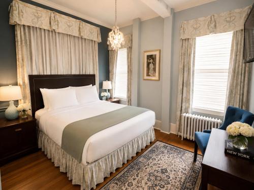 a bedroom with a bed and a desk and a chair at Bellevue Manor in Newport