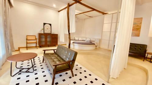 a living room with a couch and a table and a tub at Siquijor Jade ocean resort in Siquijor