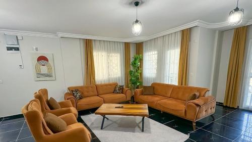 a living room with couches and a coffee table at Villa Incir in Kuşadası