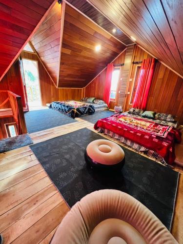 a room with two beds and a bean bag chair at The Cloud-Line Cabana in Nuwara Eliya