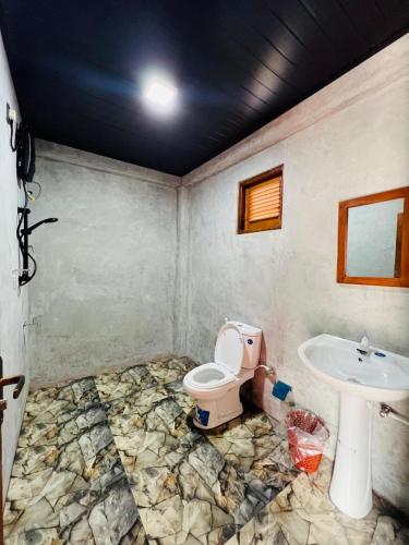a bathroom with a toilet and a sink at The Cloud-Line Cabana in Nuwara Eliya
