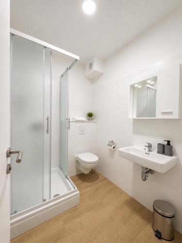 a bathroom with a shower and a toilet and a sink at Aparthouse Penelope in Supetarska Draga