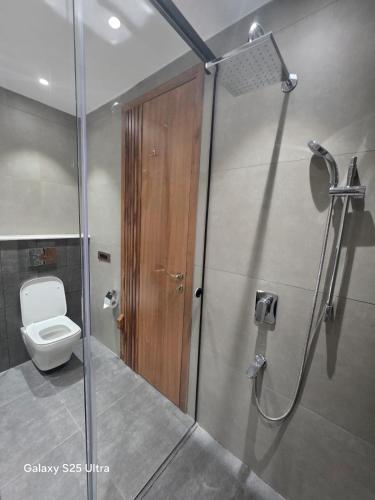a bathroom with a shower and a toilet in it at Avio Hotel in Chandigarh Airport