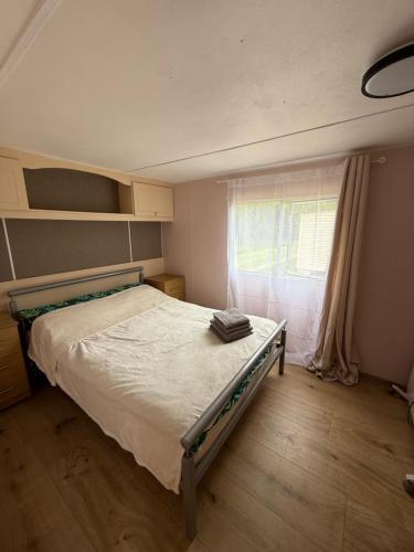 a bed in a room with a window and a bed frame at The Sea Spot in Zvejniekciems