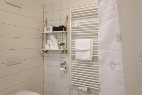 a bathroom with a shower and a toilet and towels at Zirbitzblick in Mönchegg