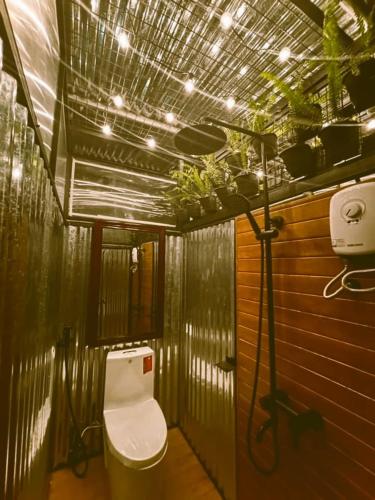 a bathroom with a toilet in a room at FREESCAPE Quiet Reset - Lakeside Mountainview in Cavinti
