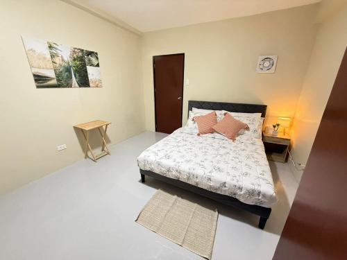 a bedroom with a bed with pillows on it at Thousand Journey 2 in Naga