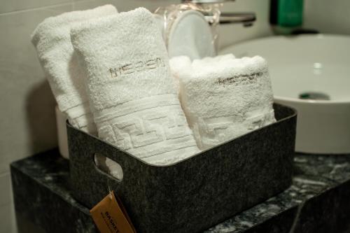 a basket of towels on a counter in a bathroom at Wezen in Vama Veche