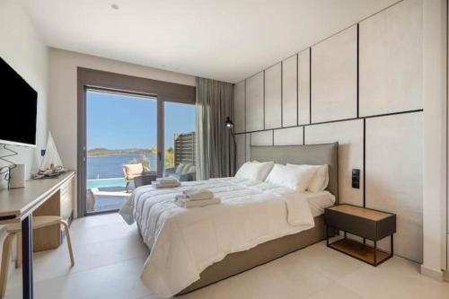 a large bedroom with a large bed and a desk at Villa Incanto in Nydri