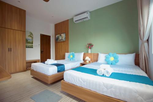 a bedroom with two beds with towels on them at Emlyhome Hanriver in Danang