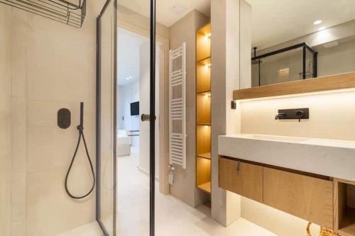 a bathroom with a shower and a sink and a mirror at Villa Incanto in Nydri