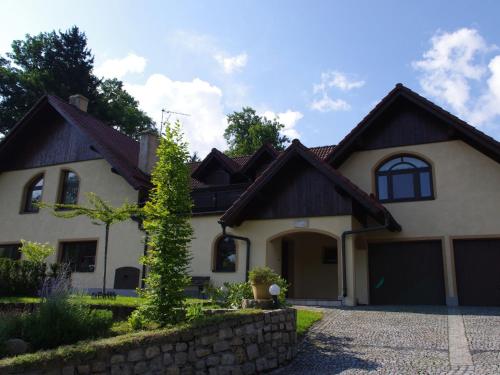 a white house with a brown roof at Spacious holiday home in Przesieka with sauna in Przesieka