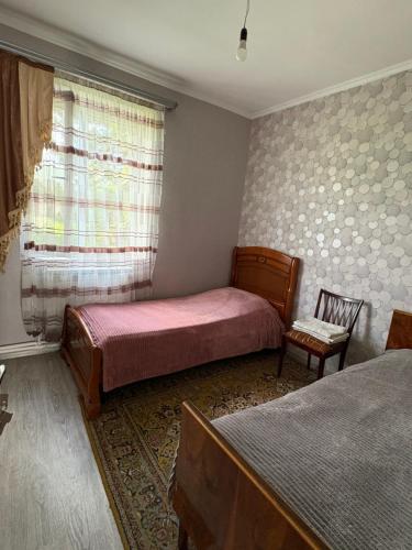 a bedroom with two beds and a window at fam rest in Garni