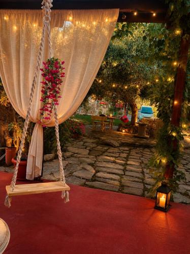 a swing with a bunch of flowers on it at Villa Aggeliki in Prinos