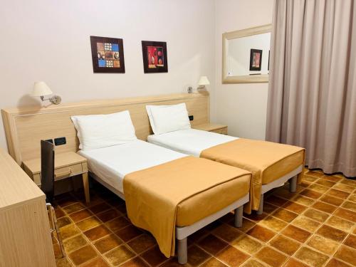 a hotel room with two beds in a room at HOTEL Monte Cimone in Caldonazzo