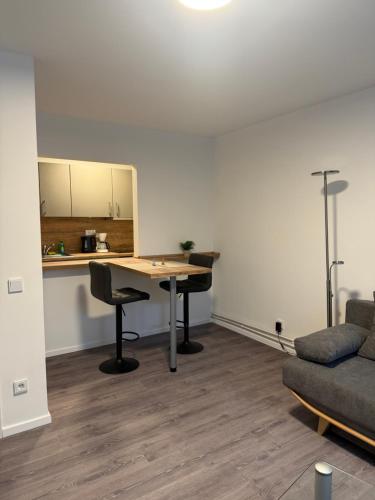 a living room with a table and a couch at Dünenhaus Souterrain Strandallee 3 in Timmendorfer Strand