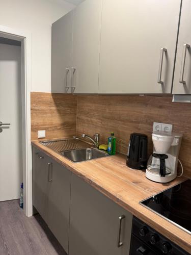 a kitchen with a sink and a mixer on a counter at Dünenhaus Souterrain Strandallee 3 in Timmendorfer Strand