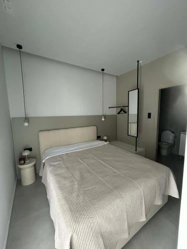 a bedroom with a large bed and a toilet at Angelica Suites Keramoti Area in Keramoti