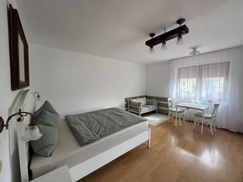 a bedroom with a bed and a dining room at GaLiBa Vendégház in Jenő