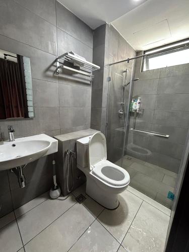 a bathroom with a toilet and a shower and a sink at K Avenue by FRHome, 2 bedroom apartment within 5 min to KKIA airport in Kota Kinabalu