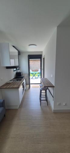 a kitchen with a table and a counter top at Studio between city and countryside in Lompret