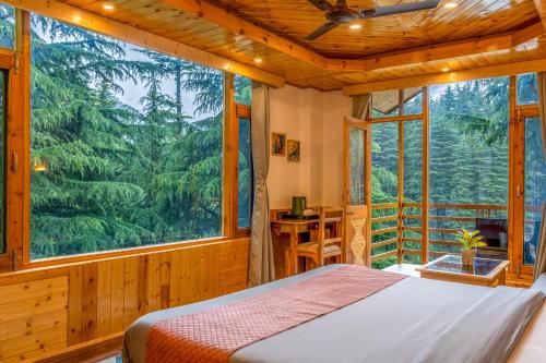 a bedroom with a bed and a large window at Getaway Stays Manali in Manāli