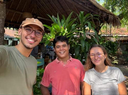 a group of three people posing for a picture at Pondok IJo Guesthouse in Yogyakarta