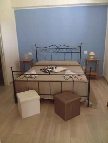 a bedroom with a bed with two boxes on it at Casa di nonna Caterina in Nemoli
