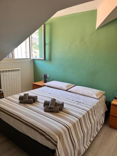 a bedroom with a bed with two towels on it at Attico Sole e Mare in Ventimiglia