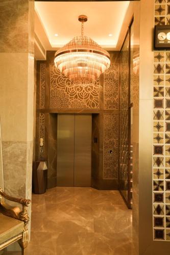 a hallway with a large chandelier in a house at raj Regent kurichy in Putuppalli