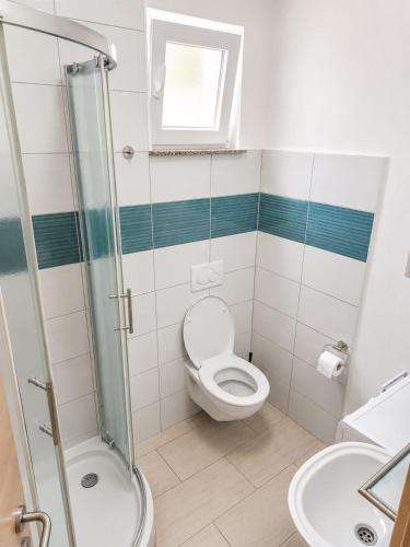 a bathroom with a toilet and a sink at Apartments Adria in Vir