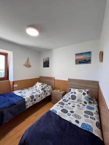 a bedroom with two beds and a window at CASA DA TORRE in O Grove