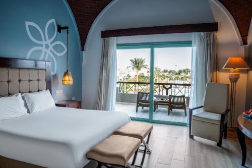 a hotel room with a bed and a balcony at Sentido Akassia Beach Resort in Quseir