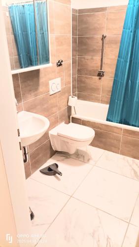 a bathroom with a toilet and a sink at Neu-Isenburg in Neu Isenburg