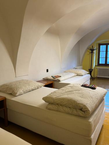 two beds in a room with an attic at Penzion Nattali in Poprad
