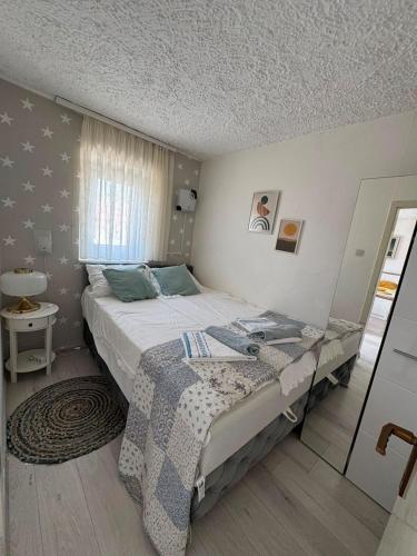 a bedroom with a large bed and a window at Vacation house Dora in Malinska