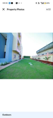 a screenshot of a building with a field of grass at HOTEL The Breeze in Pachamba