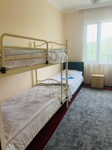 two bunk beds in a room with a window at Гостевой дом у Эмзара in Batumi