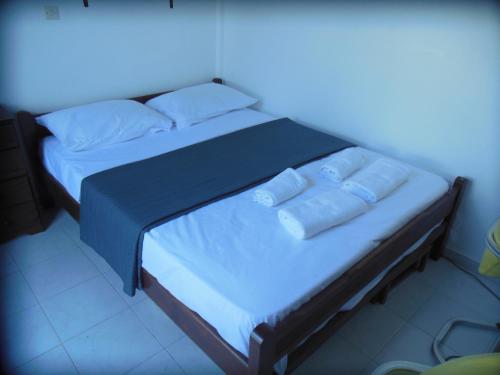 a bed with two pillows on it in a room at Nagos Home in Nagós