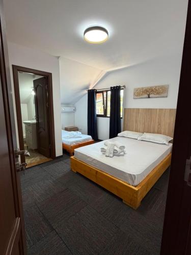 a bedroom with a large bed and a mirror at Casa Aylin in Corbu