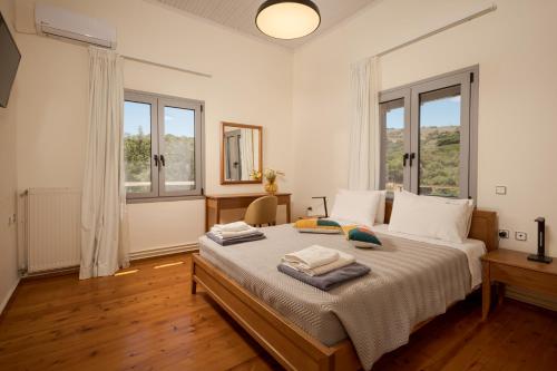 a bedroom with a bed with two towels on it at Villa Maragoudi in Arménoi