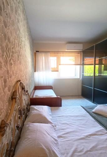 a bedroom with two beds and a window at Anavyssos Serenity Villa in Anavyssos
