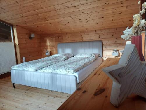 a bedroom with a bed in a wooden room at Rauchenberg Apartments in Lofer