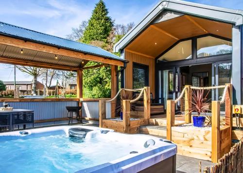 a hot tub on a patio with a gazebo at Beautiful Home In Bala, Gwynedd W in Bala