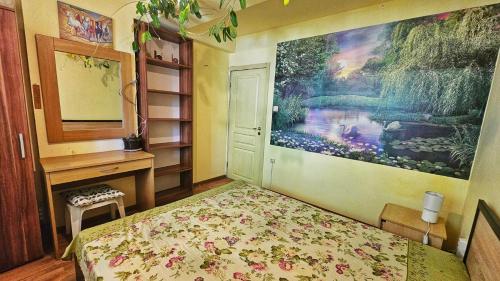 a bedroom with a bed and a desk and a painting at Harmony in Sveti Vlas